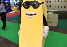 Banana mascot smiling on the floor.